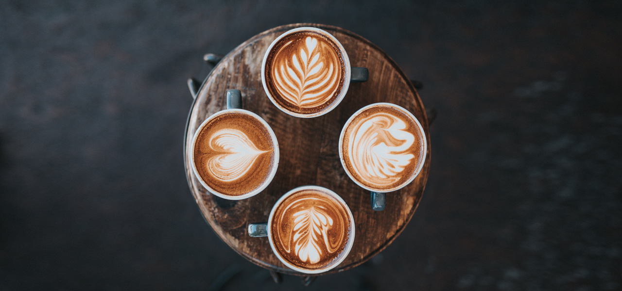 beautiful view of four cups of coffe from the top